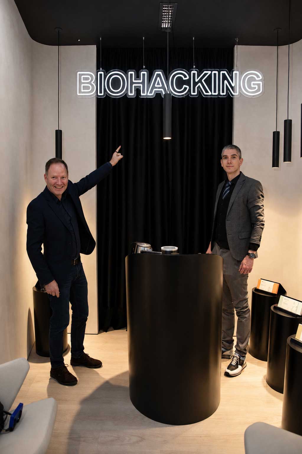 The neon BIOHACKING sign above the demo counter inside the showroom