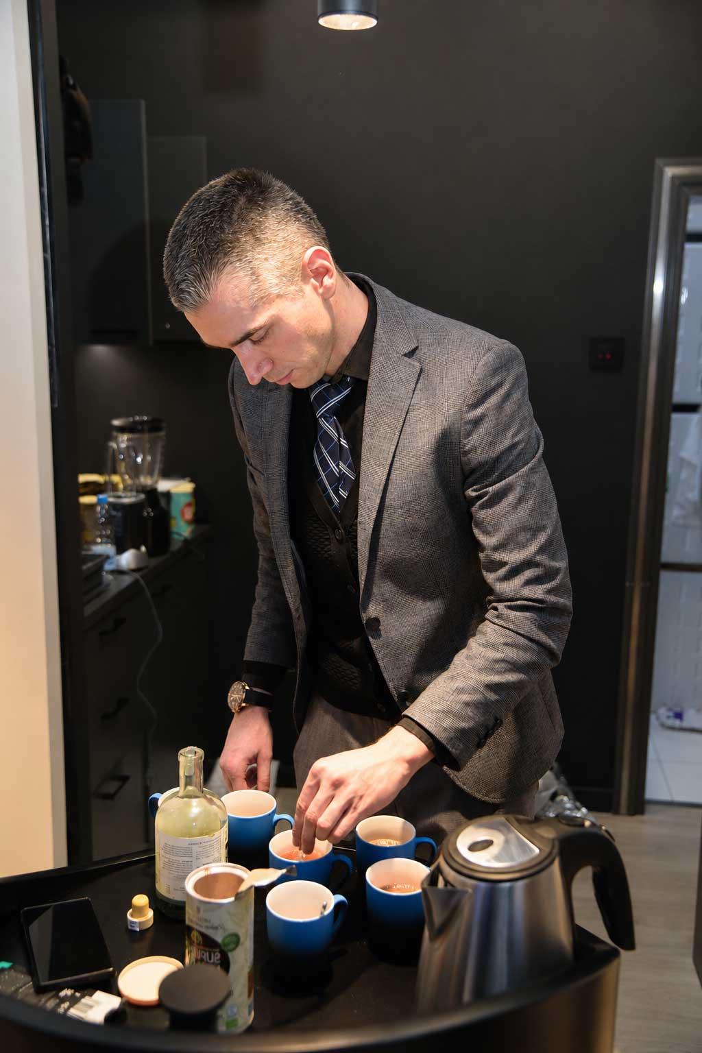 Bojan preparing tea for guests before a session